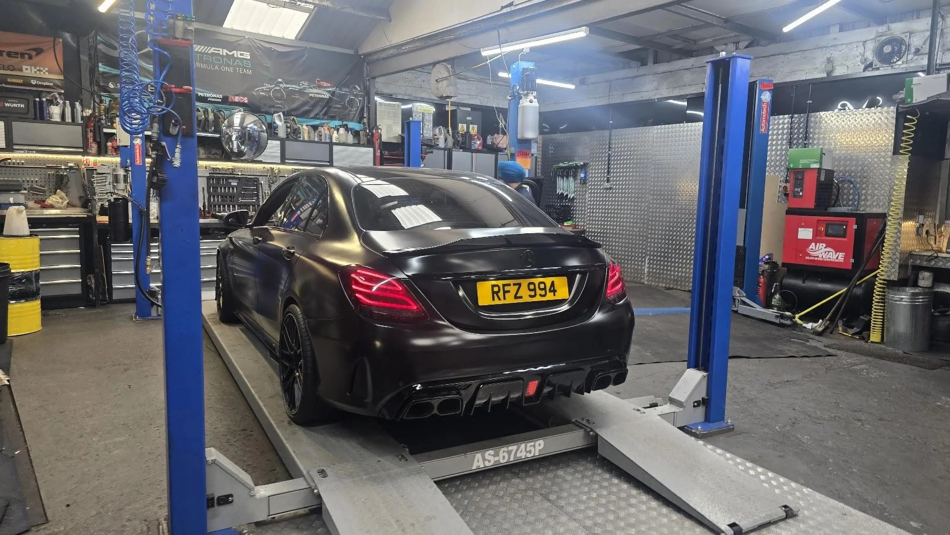 Car raised on a workshop lift for repairs at Bismillah Garage Luton