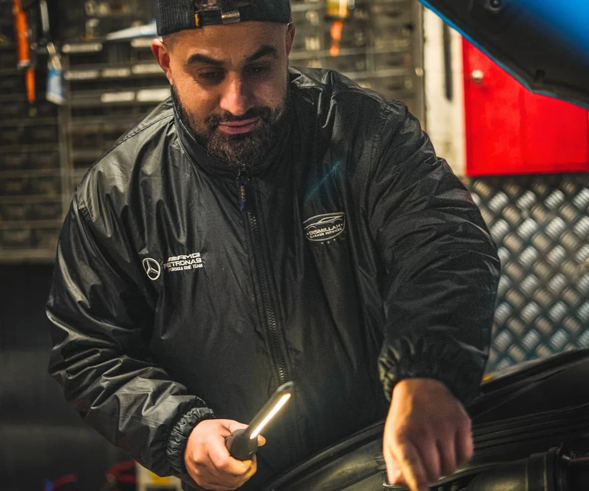 Mechanic inspecting a car engine during a service at Bismillah Garage Luton