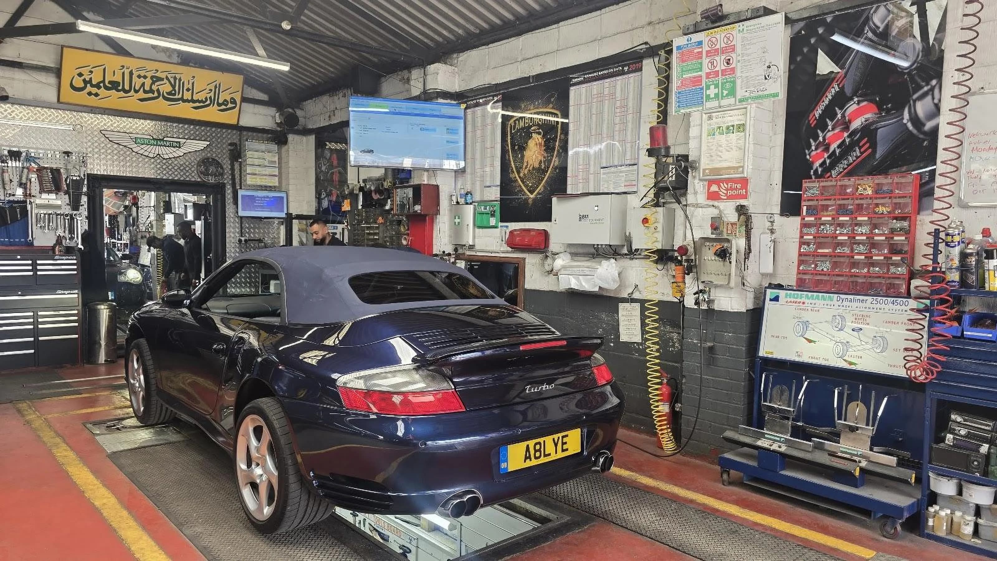 Technician carrying out an MOT inspection on a car at Bismillah Garage Luton